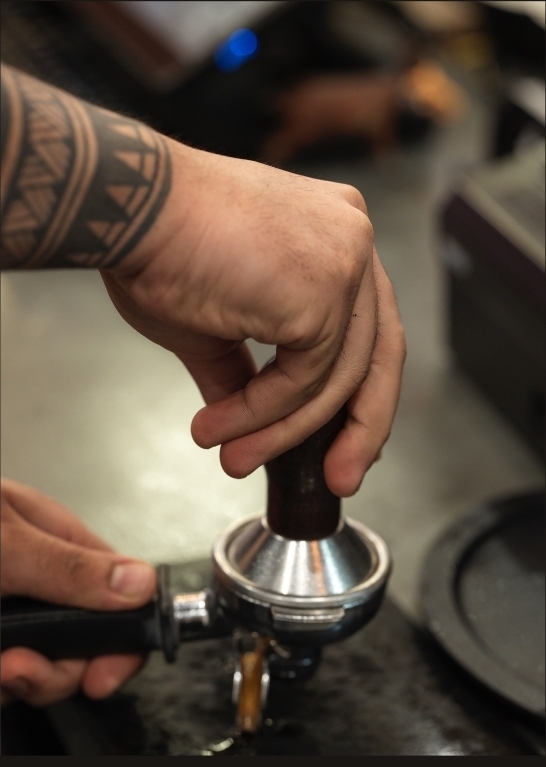 Barista tamping a shot of coffee
